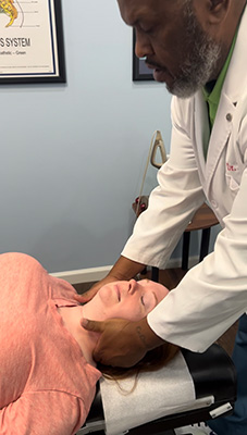 Chiropractor Winder GA Torey Evans Adjusting Patients Neck